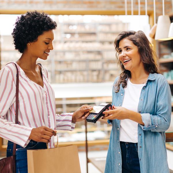 Woman paying a merchant with her debit card